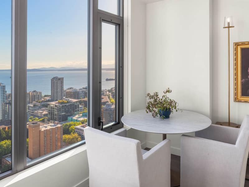 Staged dining area with water beyond
