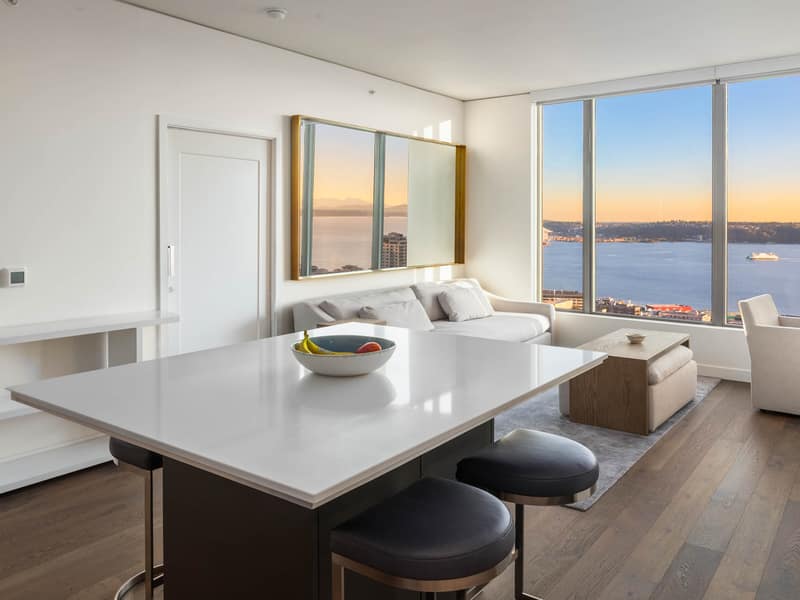 Kitchen and living area with a water view beyond