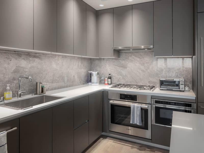 Kitchen corner with gas range and stone backsplash
