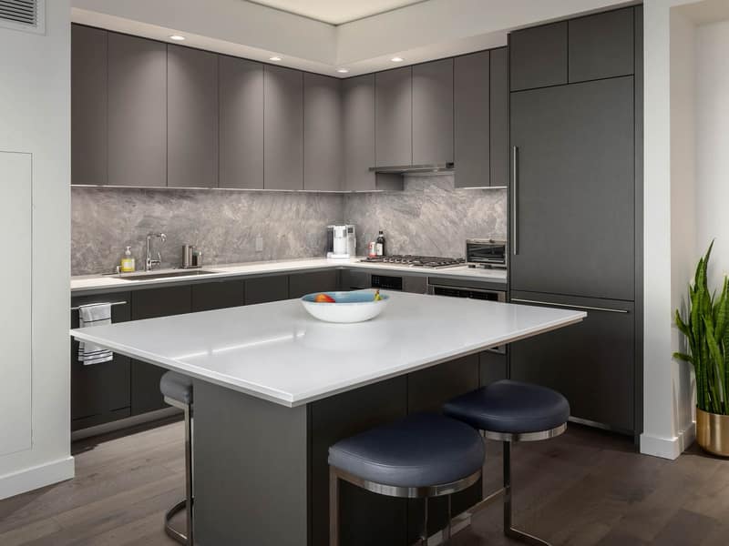 Wide view of the kitchen and gray cabinetry