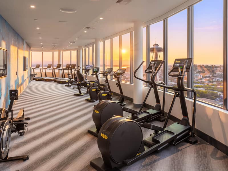 Row of cardio equipment in the fitness center at dusk