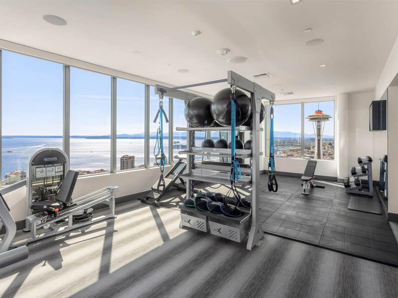 Fitness center with a city view through the windows