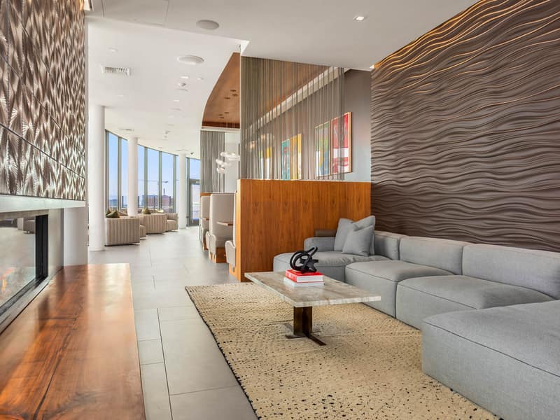 Resident lounge with a fireplace and sculptural feature wall